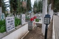 Birgi, Izmir, Turkey - 03.09.2021: local Turkish cemetery with trees and marble ornaments and Turkish flag in Birgi village