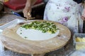 Turkish housewife cooking gozleme, traditional Turkish food cuisine. Gozleme stuffed with cheese and herbs. High quality