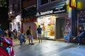 A Turkish ice cream salesman sells from a spice and candy shop at night in the Sultanahmet district of Istanbul, Turkey Royalty Free Stock Photo