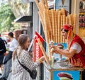 Turkish ice cream salesman with traditional costumes making an entertaining show while giving ice cream to young tourist girl in