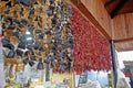 A row of dried red chilies and olives hanging up