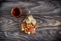 Turkish joys with different nuts is a glass of tea and a spoon. Eastern sweets. Traditional Turkish delight Rahat lokum on a Royalty Free Stock Photo