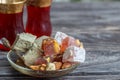 Turkish joys with different nuts are a glass of tea and a spoon. Eastern sweets. Traditional Turkish delight Rahat lokum on a Royalty Free Stock Photo