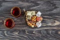 Turkish joys with different nuts is a glass of tea and a spoon. Eastern sweets. Traditional Turkish delight Rahat lokum on a Royalty Free Stock Photo