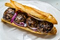 Turkish Kofte Ekmek / Meatball Sandwich with Red Onions. Traditional Fast Food from Turkey