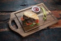 Meatball Sandwich with tomatoes, onion and green pepper on rustic wooden background