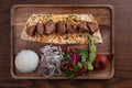 Turkish lamb sis kebab with rice and vegetables on wooden table