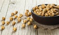 Turkish leblebi famous nut stack of yellow roasted chickpea in brown bowl on wooden rustic background, roasted chickpeas Royalty Free Stock Photo