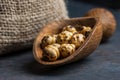 Turkish leblebi famous nut yellow roasted chickpea with burlap sack and wooden shovel on wooden background , roasted chickpeas