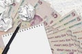 5 Turkish lira bills and balls of crumpled paper with blank notepad. Bad ideas or less of inspiration concept. Searching ideas for