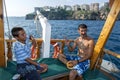 A Turkish man fishing from a cruise boat in Antalya Bay in Turkey. Royalty Free Stock Photo