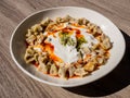 Turkish Manti with red pepper, tomato sauce, yogurt and mint. Plate of traditional Turkish food. Top view