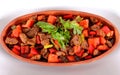 Turkish meats peppers tomatoes and greens in a clay pot and a white plate Royalty Free Stock Photo