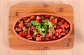 Turkish meats peppers tomatoes and greens in a clay pot on a white table Royalty Free Stock Photo