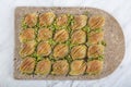 Turkish Midye Baklava Mussel Shape Baklava with green pistachio Powder and Butter Cream. Famous Turkish Gaziantep baklava