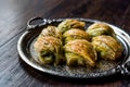 Turkish Midye Baklava Mussel Shape Baklawa with green pistachio Powder and Butter Cream in Silver Tray.