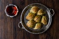 Turkish Midye Baklava Mussel Shape Baklawa with green pistachio Powder, Butter Cream and Traditional Tea in Silver Tray.