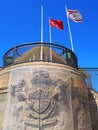 Turkish and north cyprus flags flying above and old building with the remains of a british coat of arms in nicosia Royalty Free Stock Photo