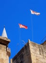 Turkish and north cyprus flying over Selimiye Mosque formerly the cathedral of Saint Sophia in nicosia cyprus against a blue sky Royalty Free Stock Photo