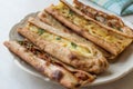 Turkish Pastry Konya Mevlana Pide with Cubed Meat and Melted Cheese.