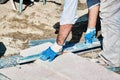 Pavement construction worker using a water level tool for balancing the tiles Royalty Free Stock Photo