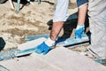 Pavement construction worker using a water level tool for balancing the tiles Royalty Free Stock Photo