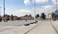 Turkish people walk at Taksim Square