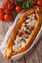 Turkish pide close up on the table and ingredients. vertical top Royalty Free Stock Photo