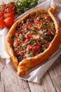 Turkish pide pizza with beef and vegetables close-up vertical Royalty Free Stock Photo