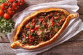 Turkish pide pizza with meat closeup. horizontal view from above