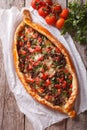 Turkish pizza with meat and vegetables closeup. vertical top vie Royalty Free Stock Photo