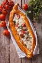 Turkish Pizza pide and ingredients close-up on a table. Vertical Royalty Free Stock Photo