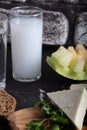 Turkish Raki with water on table with sliced melon and appetizer, traditional Turkish alcohol known as Raki, chill with Royalty Free Stock Photo