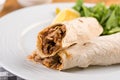 Turkish shawarma Tantuni in pita bread on wooden table. Turkish Fast food