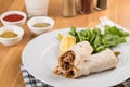 Turkish shawarma Tantuni in pita bread on wooden table. Turkish Fast food