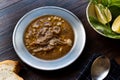 Turkish Soup Beyran with Lamb Meat, Rice, Chopped Garlic and Vinegar Sauce Served with Salad.