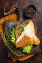 Turkish Street Food Balik Ekmek, fish sandwich with grilled mackerel fillet in a bun. Dark background. Top view Royalty Free Stock Photo