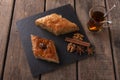 Turkish sweets baklava with tea nuts and cinnamon Royalty Free Stock Photo