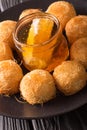 Turkish sweets balls kadaif with fresh honey close-up. Vertical