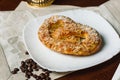 Turkish sweets - sweet bagel with filling sprinkled with pieces of nuts. Royalty Free Stock Photo