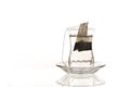 Turkish tea bags that have not started to be brewed, just left in a tea glass filled with hot water with reflection Royalty Free Stock Photo