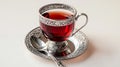 Turkish tea in a cristal Turkish tea glass and silver spoon isolated on white