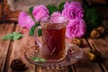 Turkish tea in a glass cup and dried dates fruits on wooden background. Ramadan food. Selective focus Royalty Free Stock Photo