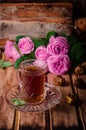 Turkish tea in a glass cup and dried dates fruits on wooden background. Ramadan food. Selective focus Royalty Free Stock Photo