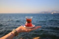 Turkish tea on the hand of a girl Royalty Free Stock Photo