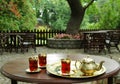 Turkish tea set with brass golden tea pot and glass cups. Traditional Turkish breakfast in nature. Eastern Middle East culture.