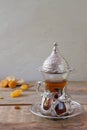 Turkish tea in a traditional glass cup with dried fruits on a wooden table. Royalty Free Stock Photo