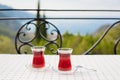 Turkish tea in traditional glass. View Oludeniz Bay and the Mediterranean Sea. Summer vacation, beach, tourism