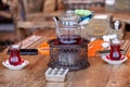 Turkish tea in traditional glasses on table. Traditional Turkish tea set: glass cup of tea, painted teapot Royalty Free Stock Photo
