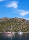 Turkish touristic boat and yacht over calm sea in Olu Deniz, Turkey Royalty Free Stock Photo